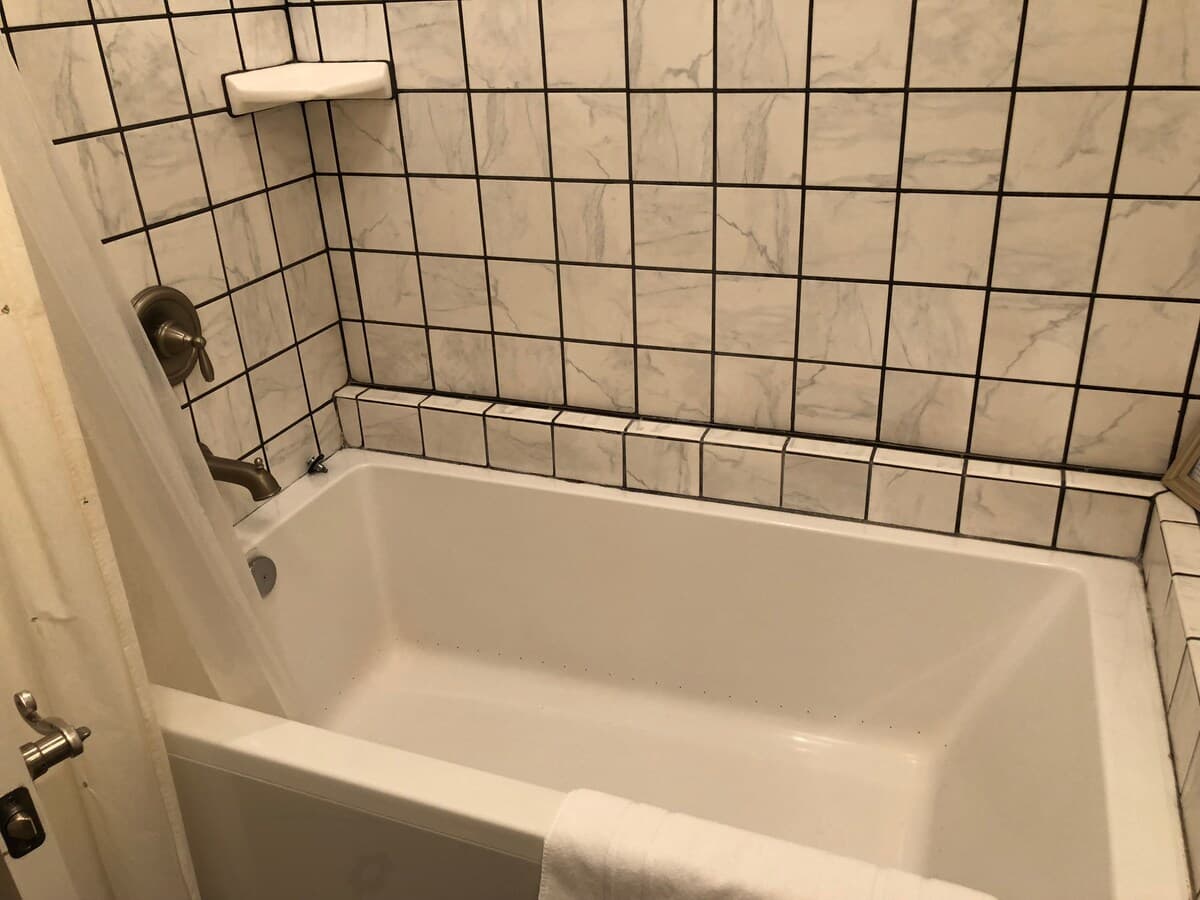 Tiled bathtub and shower surround in one bathroom